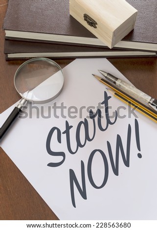 Blank paper with phrase Start Now on desk