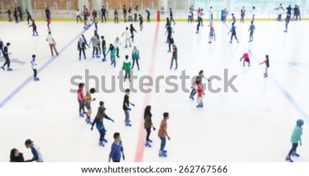 Defocused of indoor ice skating park with skating people.