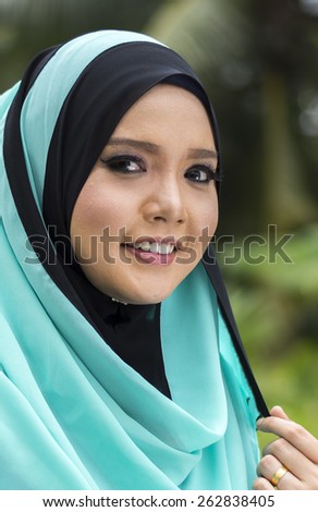 Close up of young beautiful Asian muslim woman wearing hijab.