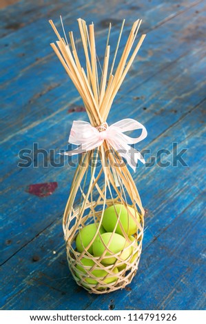 preserved egg in bamboo basketry on wood background