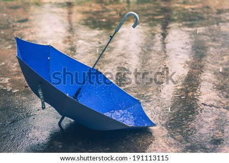 Umbrella in the rain in vintage tone
