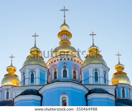 Domes and crosses of St. Michael\'s Golden-Domed Monastery in the setting sun. Kiev, Ukraine
