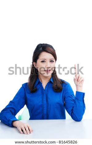 Portrait of an attractive young woman pointing upwards over white background.