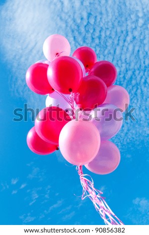 Bunch of balloons against blue sky.