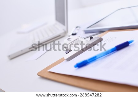 Folder for papers and pen with laptop
