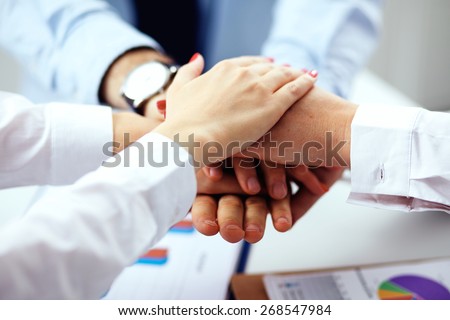 Business team are showing unity with their hands together