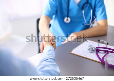 Handshake between doctor and a patient in the office