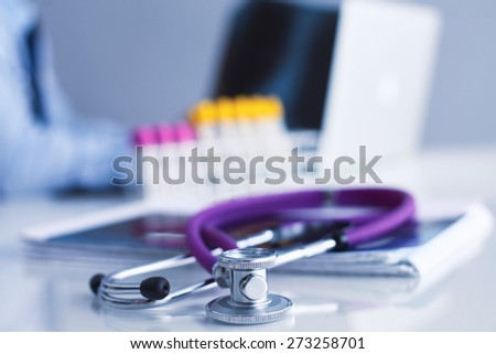 Medical doctor  sitting at table and looking patients roentgen