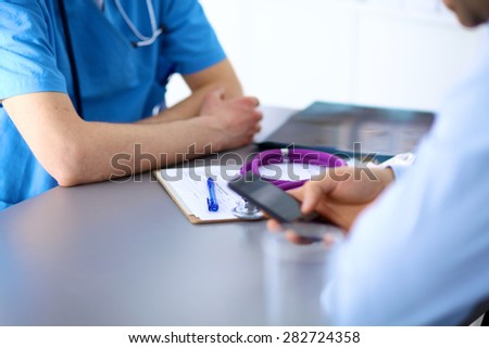 Doctor and patient sitting on the desk