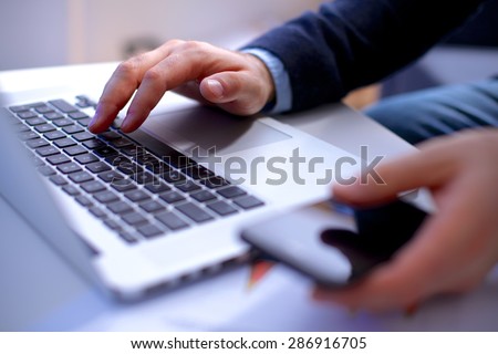 Man\'s hands typing on laptop. Internet surfing