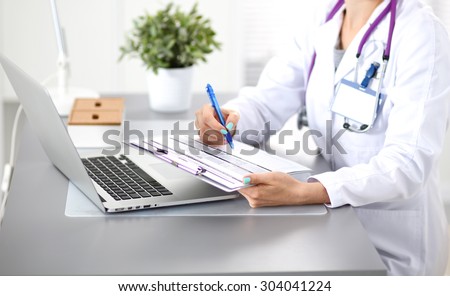 young woman doctor Close-up works at the computer