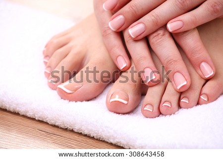 Closeup photo of a beautiful female feet with red pedicure isolated on white