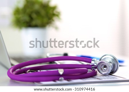 Stethoscope resting on a computer keyboard - concept for online medicine or IT support