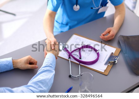 close up of patient and doctor taking notes.