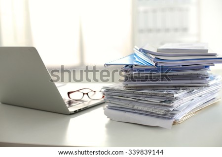 office desk a stack of computer paper reports work forms