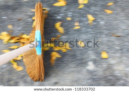 Sweeping the floor with moving motion over ground and leaves
