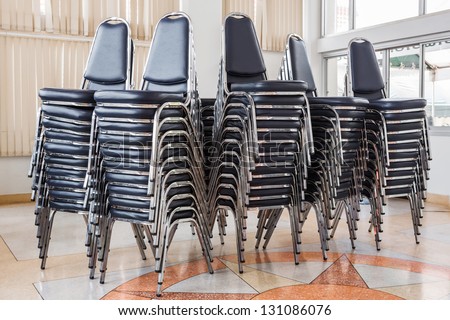 Stack of chairs in meeting room