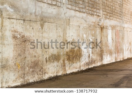 Weathered and grunge concrete wall inside old warehouse building