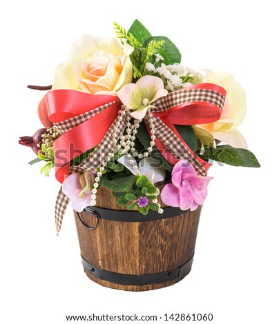 Bouquet of flowers in wood bucket isolated on white