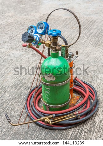 close up small gas welding kit on grunge concrete floor