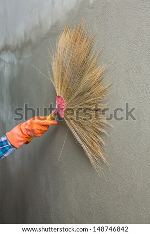 Concrete plaster cleaning by broom in construction site