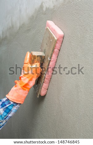 Concrete plaster cleaning by sponge in construction site