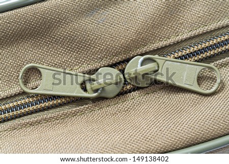 Close up green color plastic zip on brown bag
