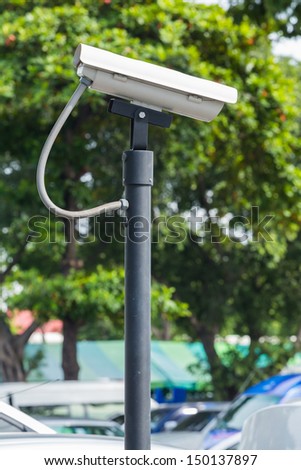 White CCTV camera watching for security 24 hours at car park