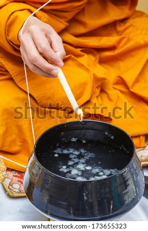 Close up monk do holy water in wedding ceremony