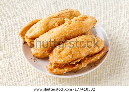 Close up deep fried sliced cultivated banana on ceramic dish - deep focus image