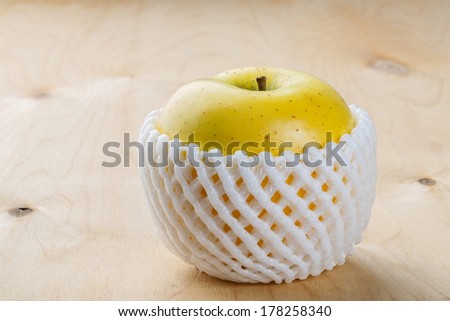 Close up Toki Japanese apple with fruit protection foam on wooden table