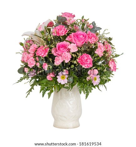 Close up pink color carnation roses chrysanthemum lily flower bouquet in glass vase isolated on white