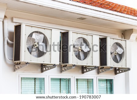 Close up air conditioners installation outside of building near glass windows