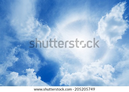 Sun halo or corona phenomenon in cloudy and blue the sky