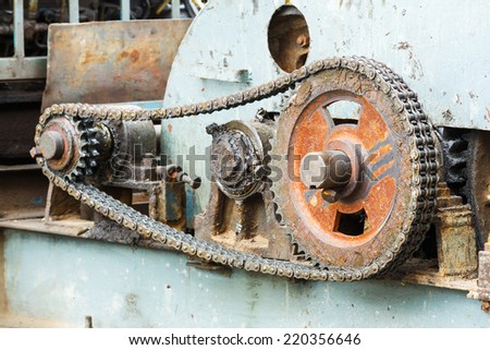 Close up dirty old gear and chain on piling machine