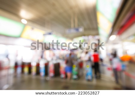 Abstract blurred people using automatic ticket gates at train station
