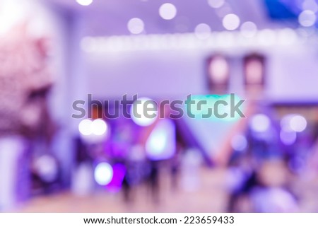 Abstract blurry people in exhibition event hall