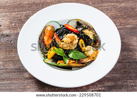 Close up spicy squid ink spaghetti with green mussel and shrimp
