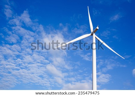 Close up Wind turbine electric generator on blue sky and white cloud