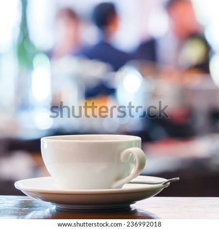 Close up cup of espresso with blurred people background in restaurant