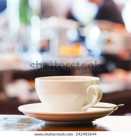 Close up cup of espresso with blurred people background in restaurant