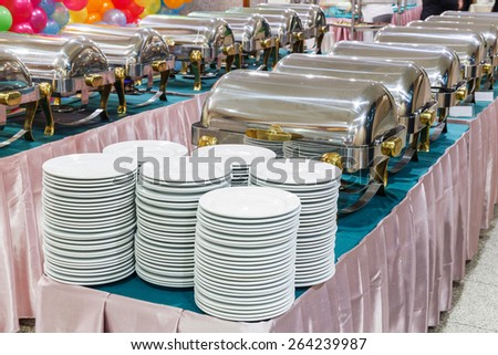 Close up stainless steel countertop food warmer and dish on table, catering concept