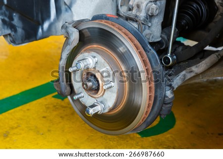 Car brake repairing in garage, automotive service station