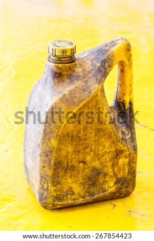 Close up old and dirty car engine oil gallon, plastic container, automotive maintenance service