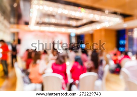 Abstract blurred people with light bokeh in restaurant