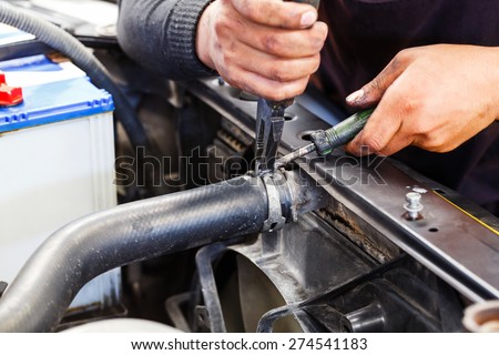 Close up motor vehicle mechanic repairing car radiator, automotive maintenance service