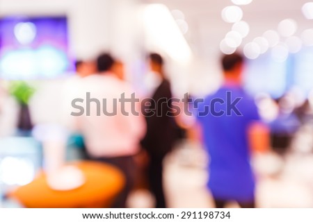 Abstract blurred people at party with light bokeh background