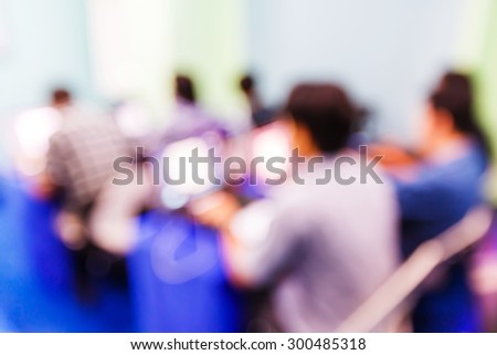 Abstract blurred people in seminar room, education concept