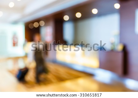Abstract blurred bellboy trolley suitcase pass reception counter in hotel, customer service 
concept