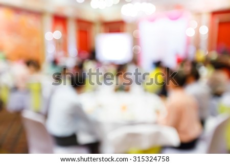 Abstract blurred people in restaurant or food center with light bokeh background, party lifestyle